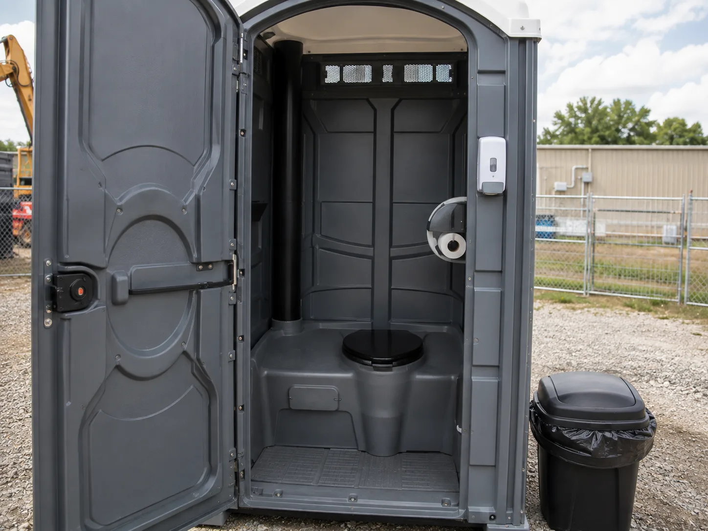 Clean portable restroom interior with properly stocked toilet paper