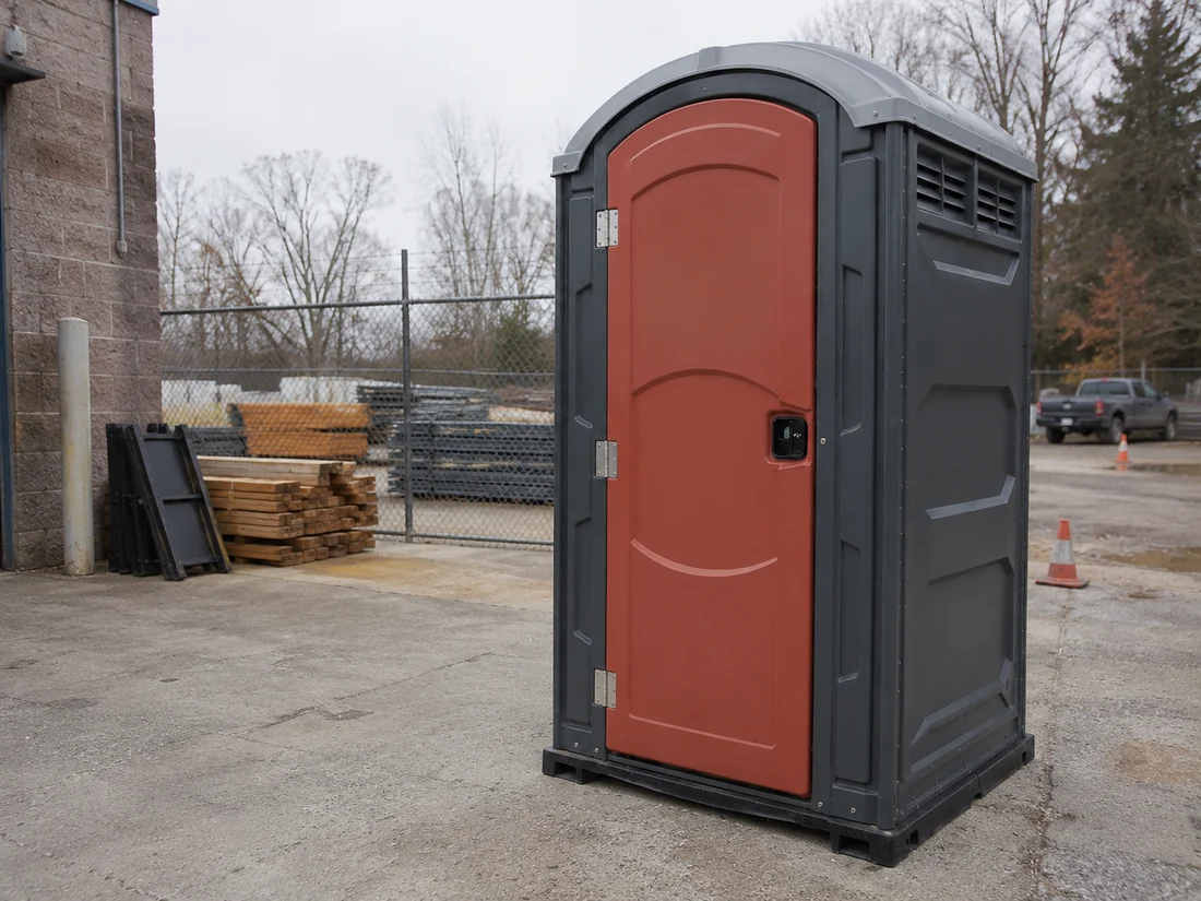 ADA-accessible portable restroom beside a level path
