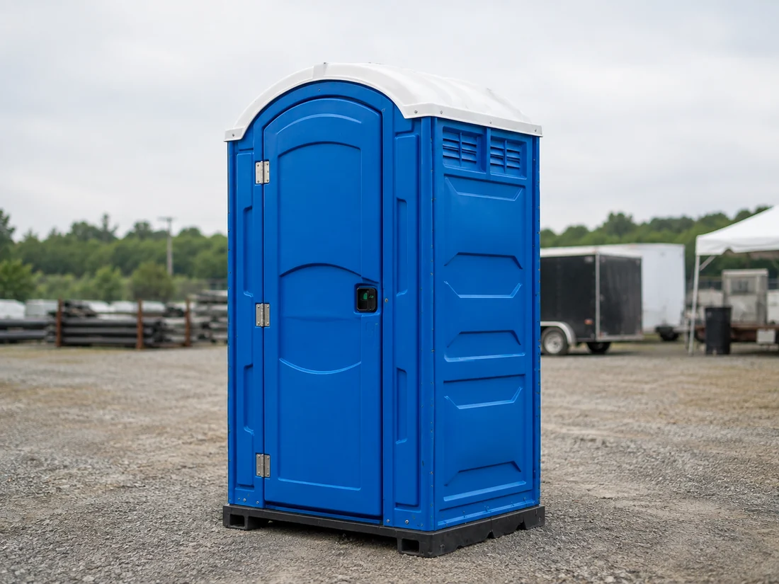 Standard portable restroom at a contractor yard
