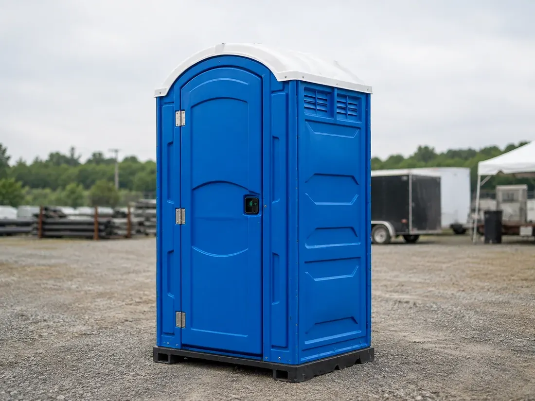 Standard portable restroom at a contractor yard